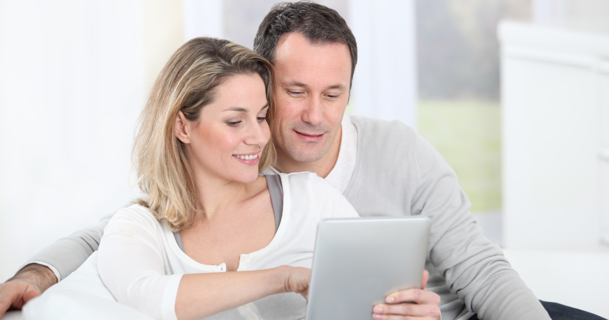 Couple sitting with tablet, marriage