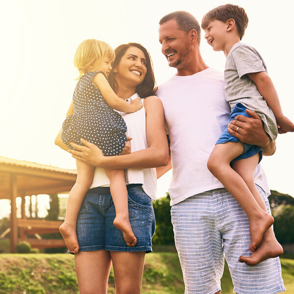 parents with their children smiling in the sun